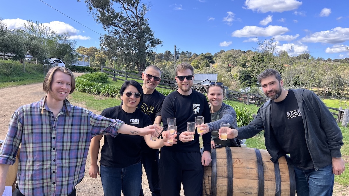 The Merri Mashers gathered around a barrel tasting their barrel aged sour beer